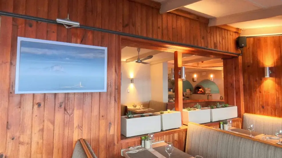 dixies restaurant view of pizza ovens with photo of roman rock lighthouse in foreground